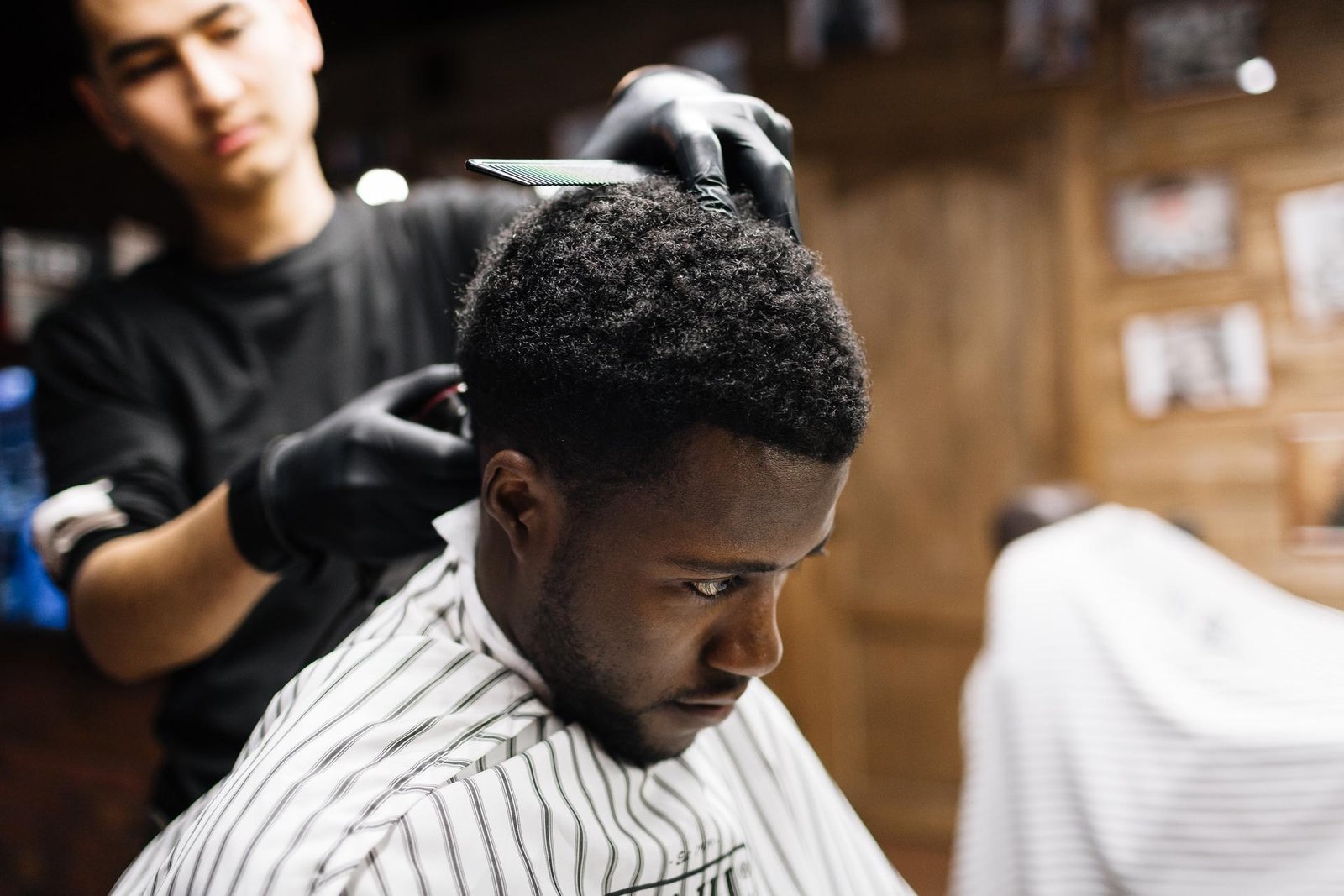 Barber giving a clean men's haircut inside a professional barber shop in Miramar FL